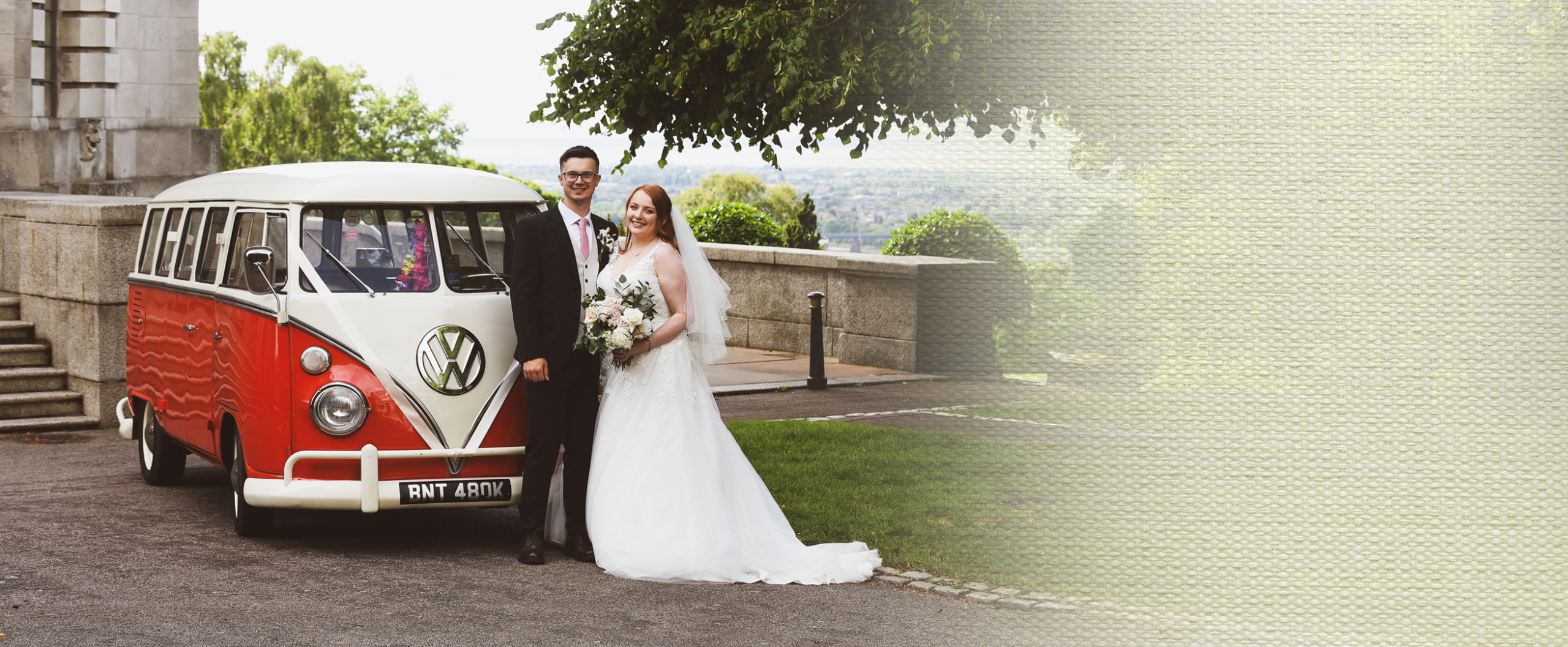 Bride and groom beside a red and white vintage VW campervan wedding car